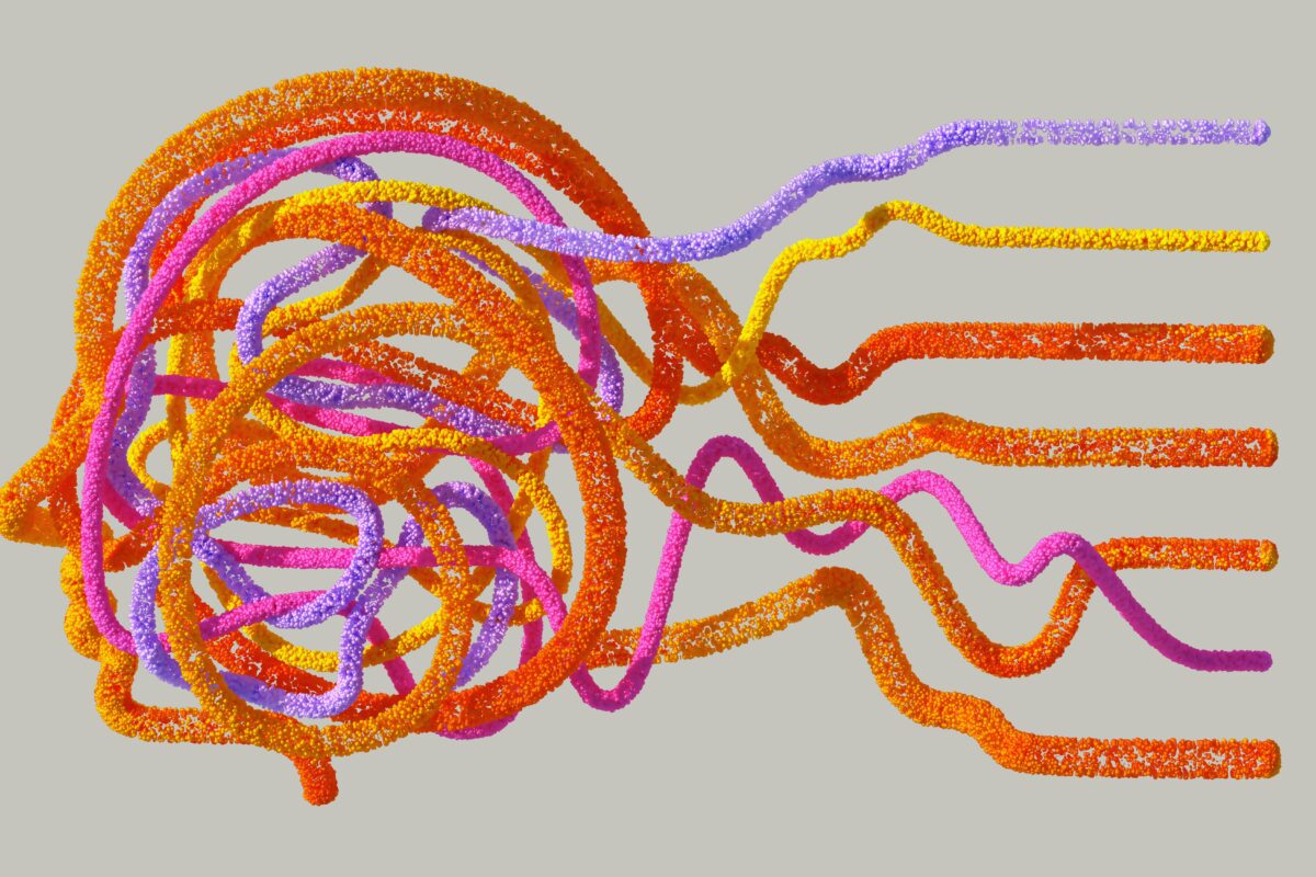 Side profile of a human head created by threads of orange, purple and yellow yarn