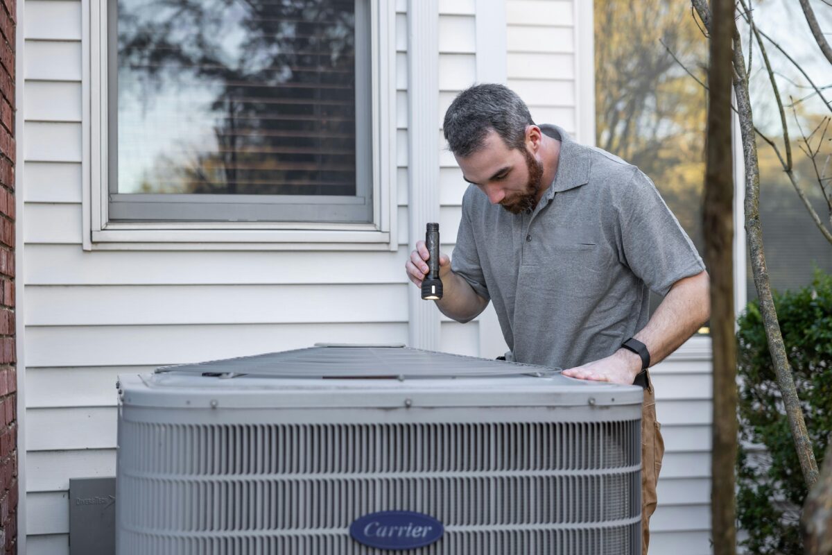 A HVAC Technician Inspecting an Outdoor HVAC Unit