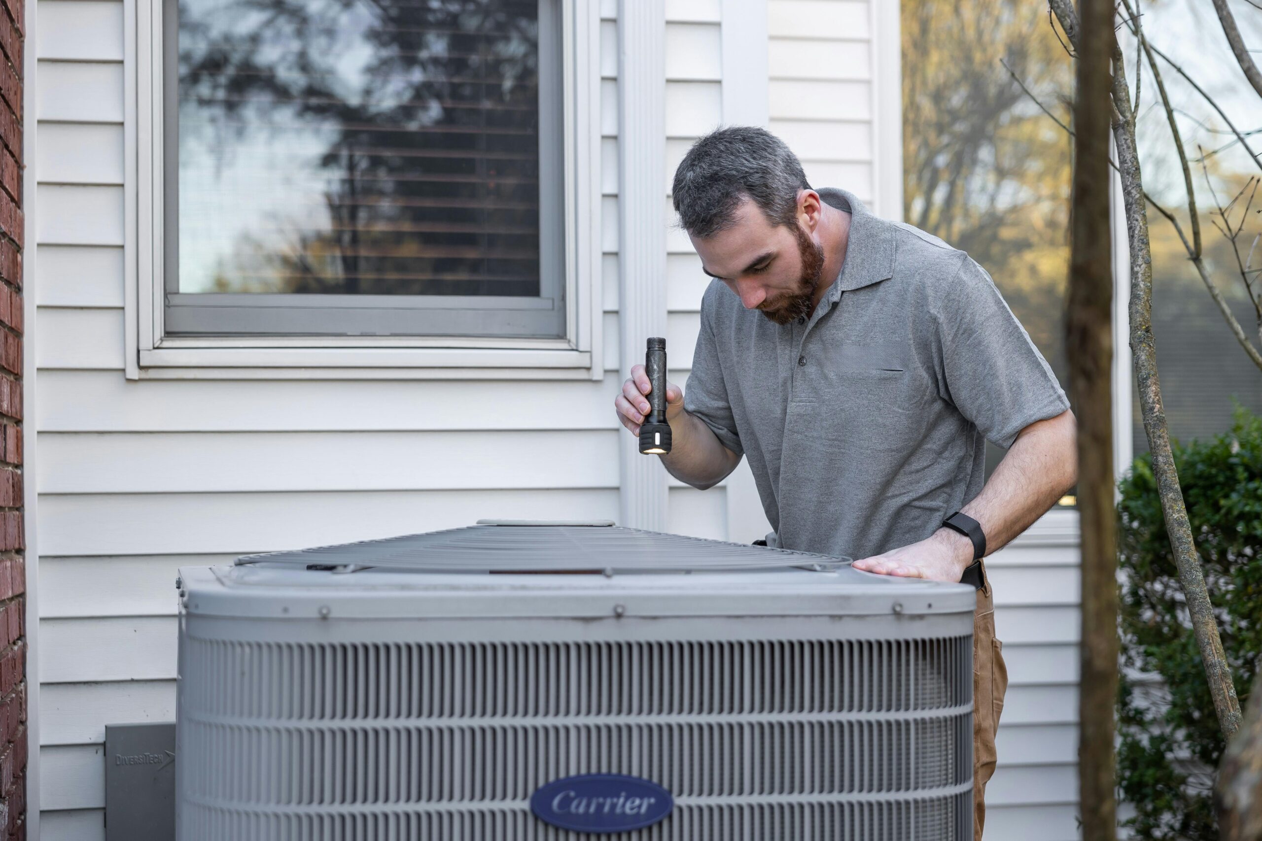 A HVAC Technician Inspecting an Outdoor HVAC Unit