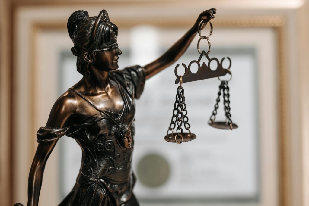 close up of a statue holding two scales (Lady Justice)