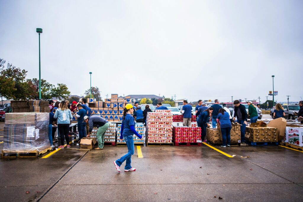 Nonprofit volunteers taking containers with cargo in terminal port.